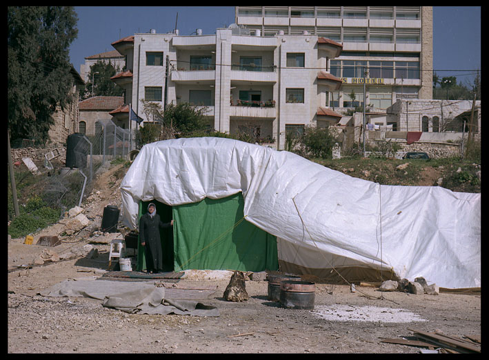Um Kamel in her tent below the home from which she was evicted in East Jerusalem
